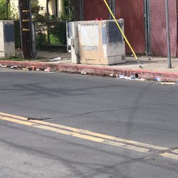 7-Eleven - Garbage dumped in the gutter and sidewalk by 7/Eleven customers on the side of their store.