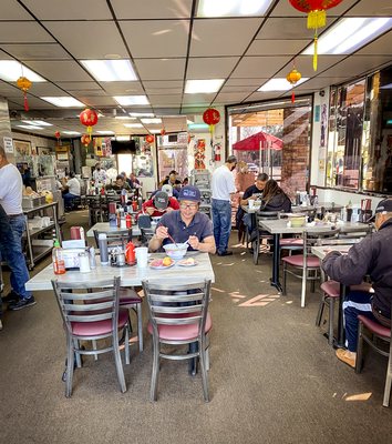 Photo of Trieu Chau Restaurant - Santa Ana, CA, US. a woman sitting at a table