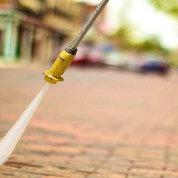 Dean Lopez Construction - a yellow fire hydrant on a brick sidewalk - General Contractors Near Me