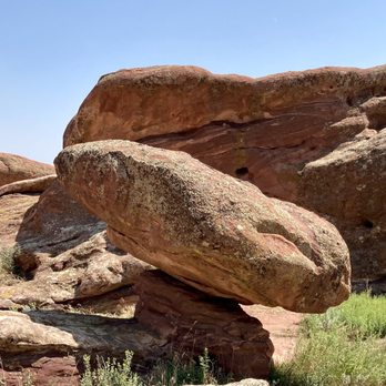 Red Rocks Park - Rocks - Red sandstone formations in a desert setting with sparse vegetation and a clear blue sky. - Parks Near Me - Morrison, Colorado