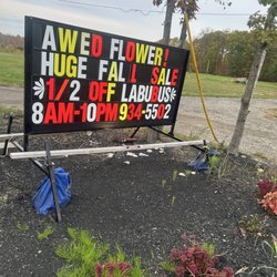 Aweo Flower - Sign in front of store by mulch