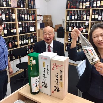 NK Wine Shop - a woman holding a bottle of sake - Beer, Wine & Spirits Near Me - Honolulu, Hawaii NK Wine Shop - a woman holding a bottle of sake - Beer, Wine & Spirits Near Me - Honolulu, Hawaii