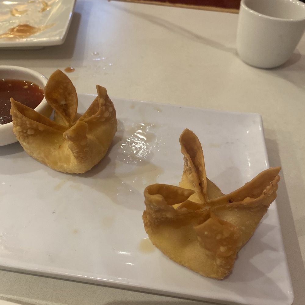 Bamboo House - What's left of the cream cheese wontons.  They were six huge ones, but we ate most of them and then placed an order to take some home. - Noodles Near Me - Humble, Texas