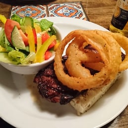 Open face steak sandwich with onion rings and garden salad Open face steak sandwich with onion rings and garden salad