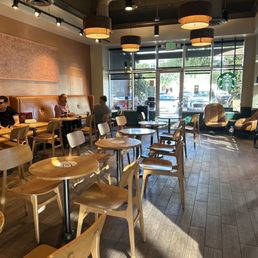 people sitting at tables in a coffee shop