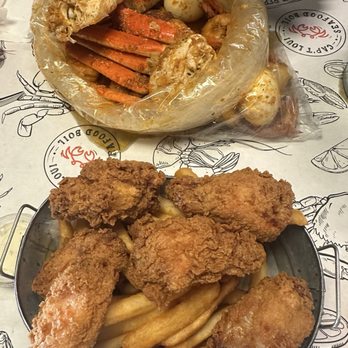 Cap't Loui Seafood Boil - Seafood boil with snow crab, shrimp, eggs, corn. Second plate is Chicken Wings Basket special - Cajun/Creole Near Me - Los Angeles, California