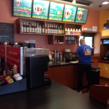 BIGGBY COFFEE - a man standing at a counter - Coffee & Tea Near Me - Southgate, Michigan