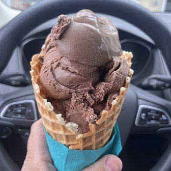 Candy Mountain Creamery - a hand holding a cone of chocolate ice cream - Ice Cream & Frozen Yogurt Near Me - Dillsburg, Pennsylvania Candy Mountain Creamery - a hand holding a cone of chocolate ice cream - Ice Cream & Frozen Yogurt Near Me - Dillsburg, Pennsylvania