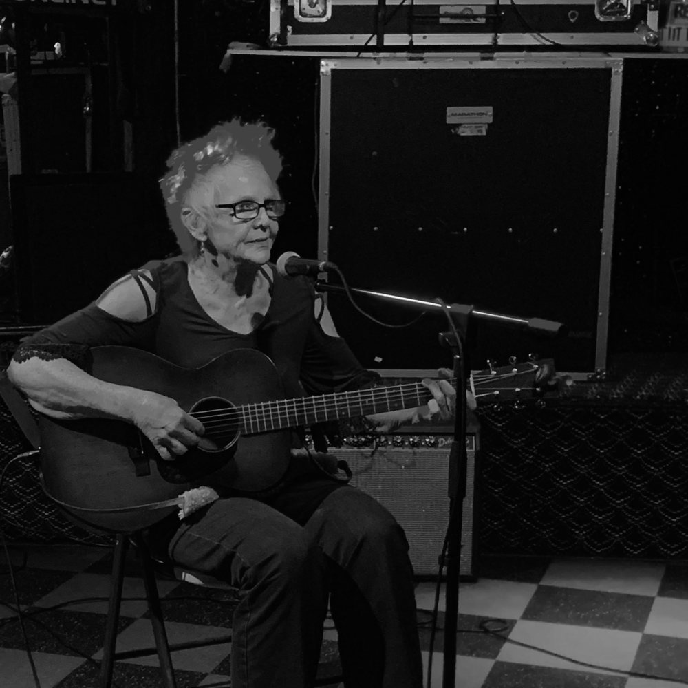 Intimo Cocktail Lounge - a woman playing a guitar - Cocktail Bars Near Me - Fresno, California