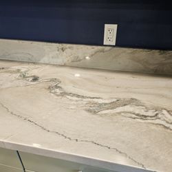 American Kitchen Cabinets - Macaubus Fantasy Quartzite - I love how the matched the veining up the backsplash