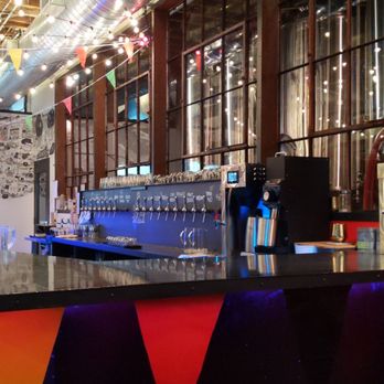 Black Bellows - a bar with a counter and colorful booths - Brewpubs Near Me - Collingwood, Ontario