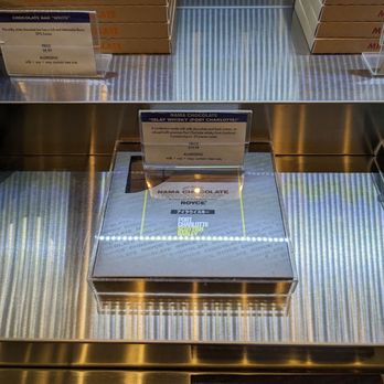 ROYCE Chocolate - oxes of pizza on a conveyor belt - Chocolatiers & Shops Near Me - Arlington Heights, Illinois