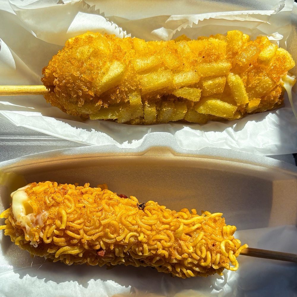 Mochinut - Potato and crispy ramen corn dogs. 1/2 cheese, 1/2 dog. - Donuts Near Me - Myrtle Beach, South Carolina