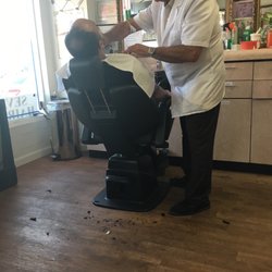 55 years experience! Hot towel shaves, lines, haircut, beard trim, you name it, he can do it! So glad we stumbled here.