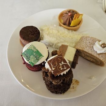 Orchids - Dessert plate highlights layered coconut cake, rich red velvet cake, layered chestnut cake (middle of the plate) and more! - Breakfast & Brunch Near Me - Honolulu, Hawaii