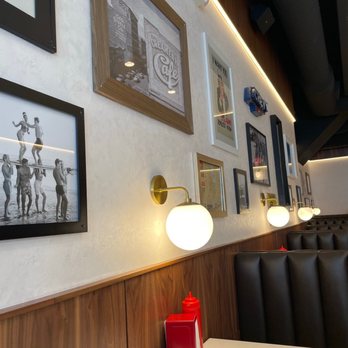 Milkman - a table with a red candle and a picture on the wall - Burgers Near Me - Cincinnati, Ohio Milkman - a table with a red candle and a picture on the wall - Burgers Near Me - Cincinnati, Ohio