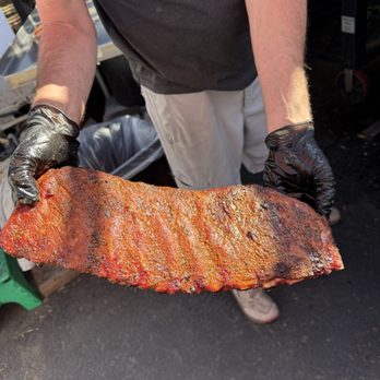 Emberz BBQ - Owner presenting the ribs while cooking - Food Trucks Near Me - Mammoth Lakes, California
