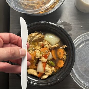Thai Zaap Cafe - a person holding a spoon over a bowl of food - Thai Near Me - Metairie, Louisiana Thai Zaap Cafe - a person holding a spoon over a bowl of food - Thai Near Me - Metairie, Louisiana