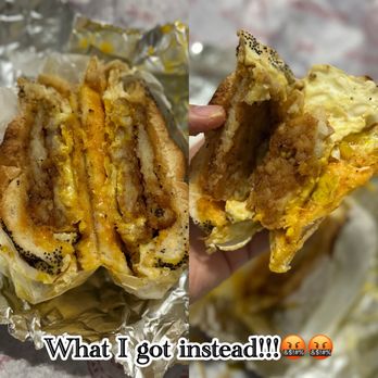Compton's - This bs ass egg and hash brown sandwich that I DID NOT even ordered. - The image displays a fried chicken sandwich with egg and cheese, cut in half to show the interior layers, including fried chicken, egg, and melted cheese. The sandwich is wrapped in aluminum foil and appears to be from a fast-food or casual eatery. The caption overlaid on the image states, 'What I got instead!!!' with angry face emojis, indicating dissatisfaction with the order received. - Sandwiches Near Me - Astoria, New York