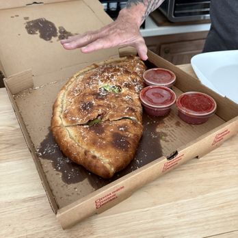 Scotty's Pizzeria - Note the hand size next to the calzone.. this is a medium! - Pizza Near Me - Port Richey, Florida Scotty's Pizzeria - Note the hand size next to the calzone.. this is a medium! - Pizza Near Me - Port Richey, Florida