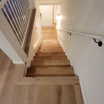 Hardwood Plus - Elegant light oak engineered hardwood installed on the main floor, with a matching light oak LVP on the staircase and in the basement. - Flooring Near Me Hardwood Plus - Elegant light oak engineered hardwood installed on the main floor, with a matching light oak LVP on the staircase and in the basement. - Flooring Near Me