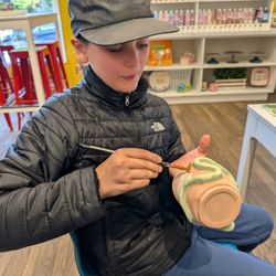 Cerami Cafe - Painting a snake cup.