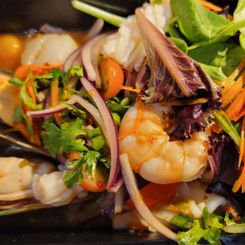 Eggplants Thai Cuisine - Sassy Seafood Salad. Raw seviche style oysters, shrimp, squid, and scallops in a mild sweet and sour lime dressing. - Thai Near Me - Temecula, California Eggplants Thai Cuisine - Sassy Seafood Salad. Raw seviche style oysters, shrimp, squid, and scallops in a mild sweet and sour lime dressing. - Thai Near Me - Temecula, California