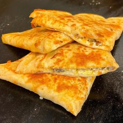 The Street Kitchen - Breakfast Quesadilla ( Golden tortilla stuffed with scrambled eggs, bacon, sausage, and shredded cheese.)