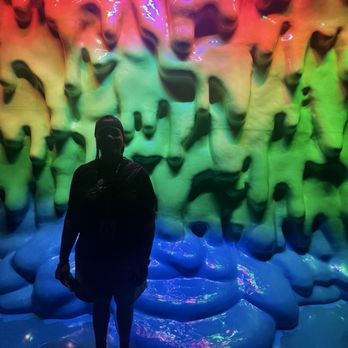 The Real Unreal - Meow Wolf - Melting looking painting in the background at Meowolf - Art Museums Near Me - Grapevine, Texas