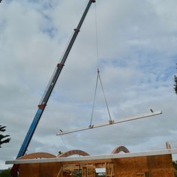 Lifting a fascia beam to far side of building. Lifting a fascia beam to far side of building.