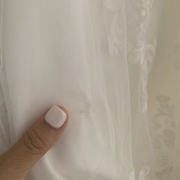 This is the center bustle, minimal damage. You can see some of the lace is stretched out. This is the center bustle, minimal damage. You can see some of the lace is stretched out.