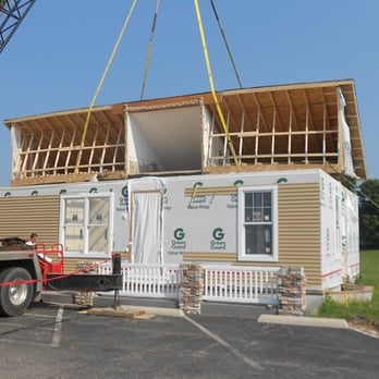 Roy's Home Center - a house being lifted by a crane - General Contractors Near Me - Gobles, Michigan Roy's Home Center - a house being lifted by a crane - General Contractors Near Me - Gobles, Michigan