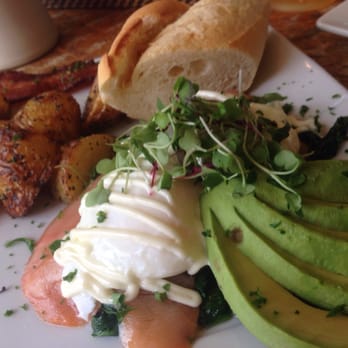 Starling Diner - Eggs Benedict on a mattress of steamed spinach and smoked lox topped with Hollandaise sauce and generous helping of micro greens - New American Near Me - Long Beach, California