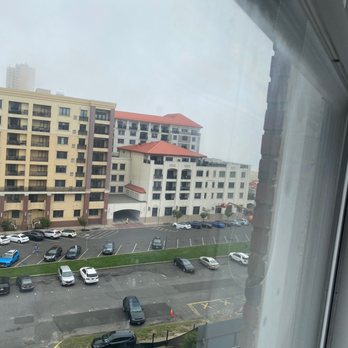Berkeley Oceanfront Hotel - Way out beyond that white building is the ocean view. Note how close I am to the window to get this photo. - Hotels Near Me - Asbury Park, New Jersey