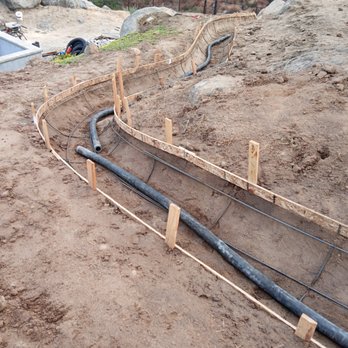Trim It Landscape - Laying the cement pipe. This pipe gets supper heavy when cement starts running through. - Landscaping Near Me Trim It Landscape - Laying the cement pipe. This pipe gets supper heavy when cement starts running through. - Landscaping Near Me