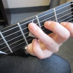 Wandering Minstrel Music School - Learning the chords and where to put your fingers on strings of guitar is first guitar lesson.
