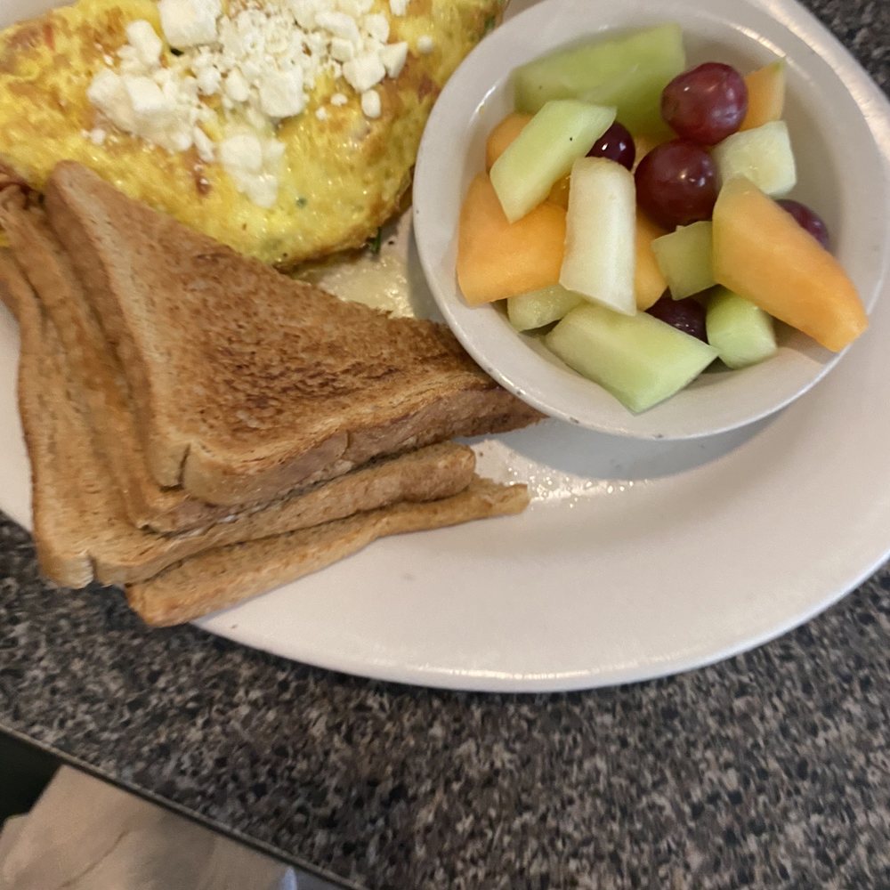 an omelet, fruit, and toast an omelet, fruit, and toast