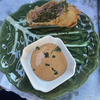 Mama Green's - Fried collard greens with ham and a jalapeño dipping sauce. - Southern Near Me Mama Green's - Fried collard greens with ham and a jalapeño dipping sauce. - Southern Near Me