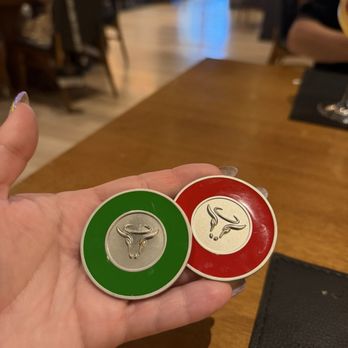 Divina Carne - Little coins to signal when you want the meats brought to you and when to stop - Steakhouses Near Me - Orlando, Florida