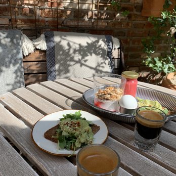 Kafé Magasinet - Espresso shots, avocado toast, and breakfast plate with yogurt and juice - Dive Bars Near Me - Göteborg, O