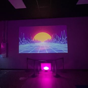 Smack My Axe - a purple light in a dark room - Axe Throwing Near Me - Saint Pete Beach, Florida