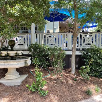 Keifer's Restaurant - The covered patio wraps around the building and is surrounded by lush landscaping. - Greek Near Me - Jackson, Mississippi