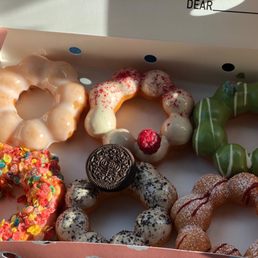 From top left: original glaze, raspberry, matcha, fruity pebbles(bottom left) Oreo, and funnel cake From top left: original glaze, raspberry, matcha, fruity pebbles(bottom left) Oreo, and funnel cake
