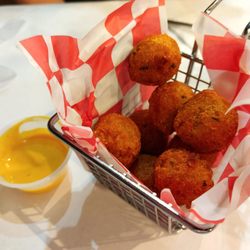 Hot, sweet and crispy hush puppies with side of honey mustard sauce