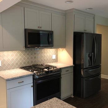 Wish List Building - a kitchen with black appliances - General Contractors Near Me - Commerce Township, Michigan Wish List Building - a kitchen with black appliances - General Contractors Near Me - Commerce Township, Michigan