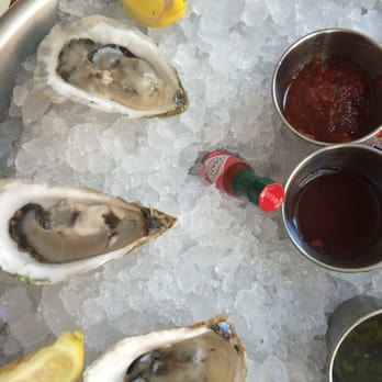 Ostra - Canadian oysters served with chimichurri, mignonette and cocktail sauce. - New American Near Me - San Antonio, Texas
