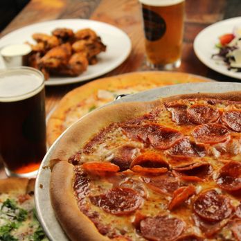 Martin City - a pizza with pepperoni and a salad - Pizza Near Me - Lee's Summit, Missouri