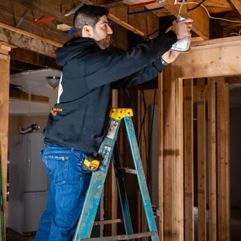 RJT Remodeling - a man on a ladder working on a light fixture - General Contractors Near Me RJT Remodeling - a man on a ladder working on a light fixture - General Contractors Near Me