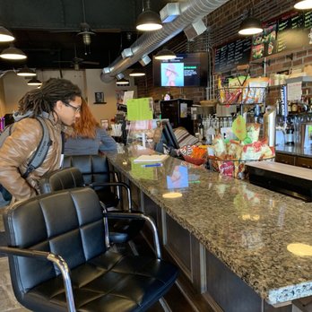 Jaded Java - a woman sitting at a bar - Coffee & Tea Near Me - East Moline, Illinois