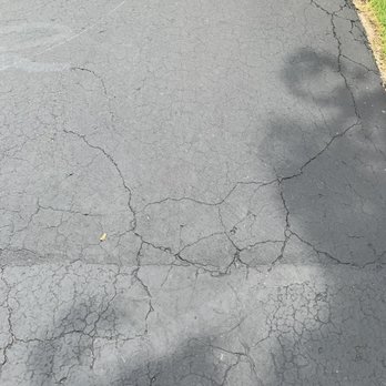 Guardian Sealcoat & Paving - a road with cracks - Masonry/Concrete Near Me - Highland, Michigan